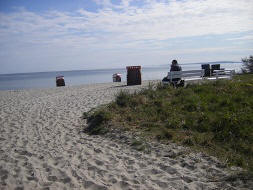 sand beach shore with roofes wicker beach chairs